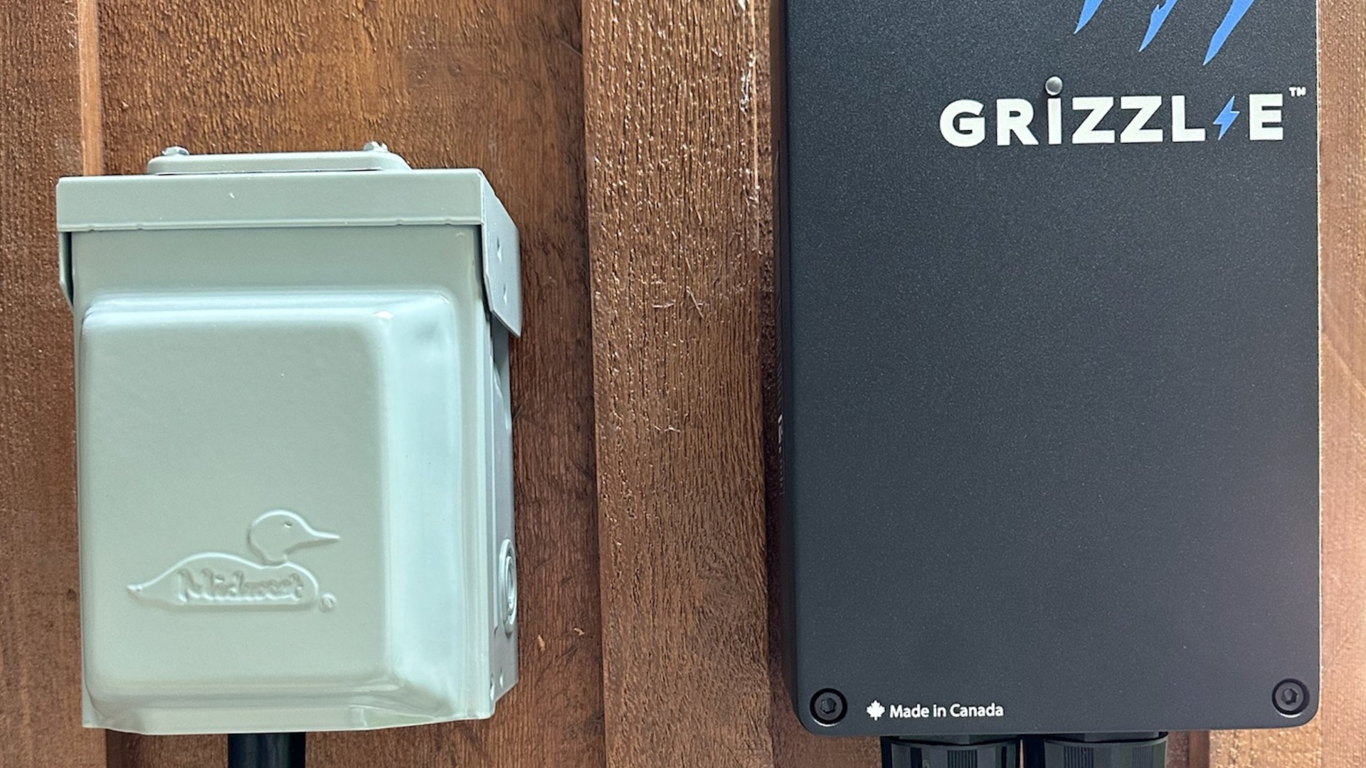 A Grizzle EV charger installed on the exterior of a house.